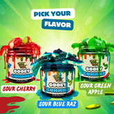 Three containers of Gooey Gummies with flavors Sour Cherry, Sour Blue Raz, and Sour Green Apple on a green background.